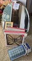 Front view of all items combined showing mirror, boxed butterfly scarf hanger, and blue plastic hot roller case
