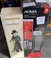Boxes of NOMA digital ceramic heater and Jacqueline Kent Collection caroler figurine Mr. Birmingham