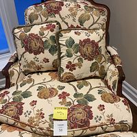 Front view of chair with matching ottoman and two pillows