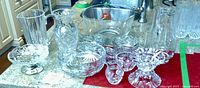 Photo showing assorted crystal pitchers, candy dishes, and other crystal items on kitchen counter
