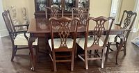 Front view of dining table fully extended with all eight chairs