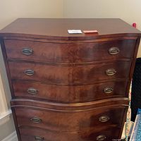 Front view of chest showing three upper drawers with serpentine front