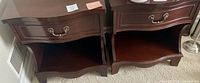 Front-angle view of both mahogany end tables side by side showing overall design and finish