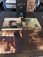 Four vinyl albums arranged in two rows showing front covers: Donovan, Johnny Nash, Cher, Bill Withers.