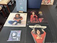 Photo of three Cleo Laine vinyl albums and one CD on a dark surface, showing album cover artwork and CD case.