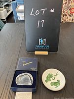 Photo showing lot number sign with Dartington Crystal box and Wedgewood miniature plate on table