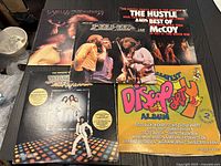 Overview photo showing five disco vinyl records including Bee Gees, Patti LaBelle and compilations.