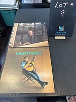 Photo of two Gordon Lightfoot vinyl albums laid flat on a black table showing album covers for 'If You Could Read My Mind' and 'Lightfoot!'.