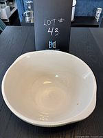 Top view showing interior of off-white ceramic mixing bowl with a visible chip.