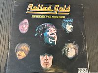 Front cover of the "Rolled Gold" vinyl album showing faces of The Rolling Stones members and gold embossed title.