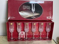 Boxed set showing six Royal Crystal Rock Opera champagne flutes with the red branded box.