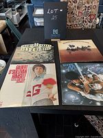 Four vinyl album covers on a black table including Blood Sweat and Tears, Boney M., Gilbert O'Sullivan, and a lunar theme album