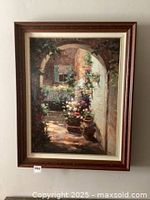 Full view of floral archway painting showing the framed artwork hanging on wall with good lighting revealing color and detail.