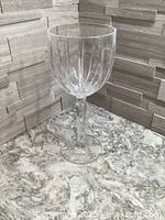 Single Marquis by Waterford Omega cut crystal wine glass on marble surface showing vertical cut pattern on bowl and tall stem.