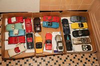 Three cardboard boxes each containing multiple die-cast Corvette model cars in assorted colors