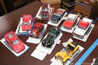 Nine die-cast car models on display cards