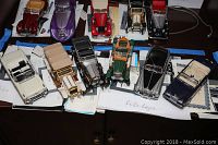 Group shot of ten model cars with COAs beneath
