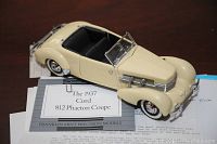 Cream colored model of the 1937 Cord 812 Phantom Coupe with detailed features and black interior.