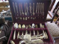Full box of Community silver plated flatware showing neatly arranged knives, forks, spoons in velvet-lined box.