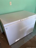 Closed view of white Kenmore chest freezer showing clean condition.