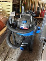 Mastervac wet/dry vacuum with attached hose and visible label showing 30L 4HP model.