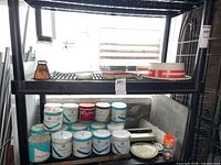 Shelf with assorted Player's tobacco tins, metal tools, decorative plates and boxes