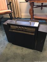 Front view of Electrohome portable record player with control knobs and carrying handle.