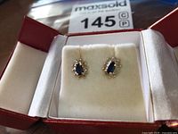 Front view of pair of earrings in red jewelry box