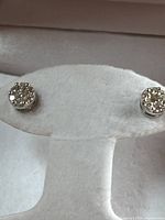 Front view of diamond cluster on white display stand