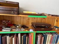 Shelf with wooden jewelry boxes, assorted small purses, coins purses, and vintage belts