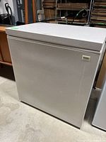 Full view of white Kenmore chest freezer with closed lid showing size and color.