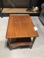 Top and side view of rectangular teak wood side table with visible age, medium brown finish, four straight legs and lower shelf.