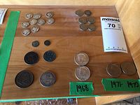 Display of several US coins including Kennedy half dollars from 1968, 1971, and 1972, plus other coins such as 50 centavos coin