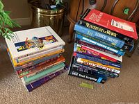 Two stacks of books including technology, business management, communication, and finance topics.