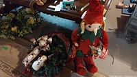 Overview of two Christmas wreaths and 27 inch elf figure