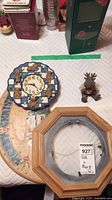 Overview of all items including teddy bear clock, resin moose figurine, wooden hanging plate frame, and wood sign beneath