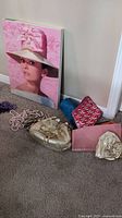 Overall view of lot items including the Audrey Hepburn print, costume jewelry, David's leather bag, Aldo purse and makeup bags.