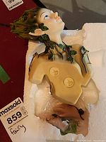 Close-up of the bust showing face and vine leaf details.