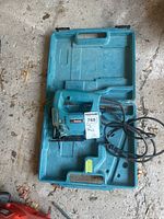 Makita jigsaw and carrying case shown from top angle revealing tool and case interior.