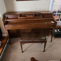 Kimball upright piano with matching bench, closed keyboard cover, showing front and side view.