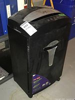 Front side view of Staples heavy duty paper shredder showing handle and product label.