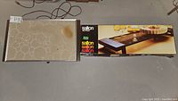 Cornwall warming tray with circular pattern and stain, next to Salton Hot Ray box with warming tray shown on box.