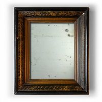 Full view of antique rectangular mirror with dark faux wood-grained carved frame.