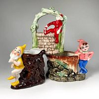 Front view of the three ceramic elf planters grouped together, showing detail and scale.