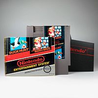 Front view of the NES cartridge label and the instruction manual showing combined Duck Hunt and Super Mario Bros 1988 branding with Nintendo Entertainment System logo.