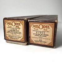 Close-up of original cardboard boxes labels showing song titles, Melodee branding and copyright details.