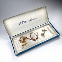 View of necklace and matching screw-back earrings in the original Vista by Richelieu blue and white box with satin lining