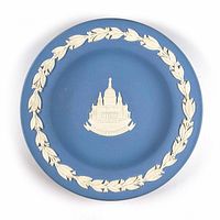 Top view of blue Wedgwood jasperware pin dish with white relief of St. Paul’s Cathedral and white laurel leaf rim decoration.