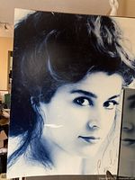 Full view of the large monochrome photo of Cecilia Bartoli showing the portrait and autograph with visible scratches.