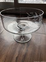 Full view of the clear glass trifle dish showing its overall shape, pedestal base, and etched floral pattern